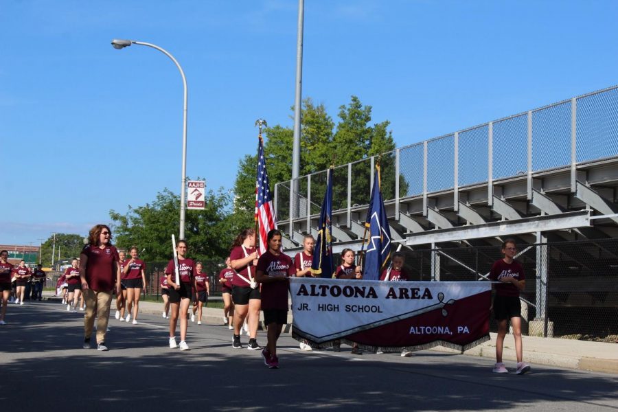 Go team! Preparing for the Hollidaysburg rivalry game, the majorettes and silks march to Mansion Park. The first game against rival Hollidaysburg on August 24, the band front and cheerleaders marched in a parade to kick off the 2018-2019 football season.