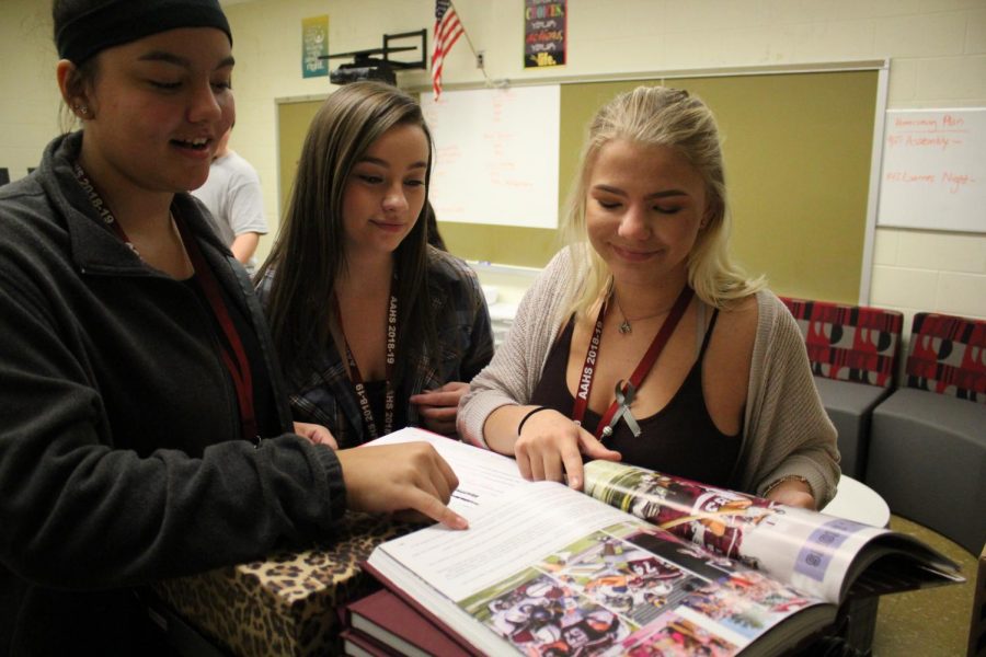 See! Mckenzie Brantner, Samantha Roller and Jenna Walter review the football page from last years book. The staff this year will be publishing  a spring book. 