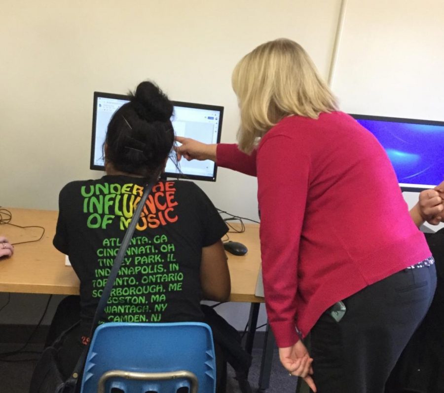 Family and Consumer Science teacher Jill Trumpbour helps junior Shianne Wilkinson with her first marking period benchmark. Students in the family and consumer science classes have to make a brochure including what is good to eat during pregnancy. 