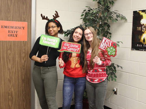 Say Cheese! Seniors Vydalia Weatherly, April Silva and Hannah Roesch spreads holiday cheer to the community at last years holiday Christmas party held by the Student Council club. This year Student Council will travel to Garvey Manor nursing home to spread holiday cheer to senior citizens. 