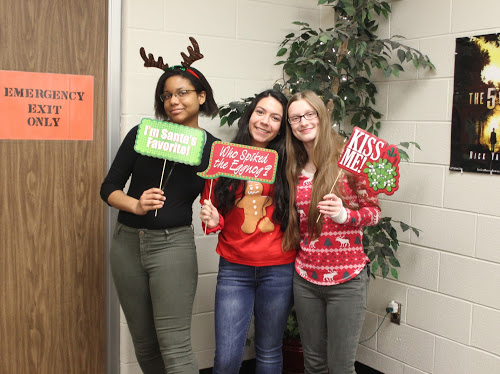 Say Cheese! Seniors Vydalia Weatherly, April Silva and Hannah Roesch spreads holiday cheer to the community at last year's holiday Christmas party held by the Student Council club. This year Student Council will travel to Garvey Manor nursing home to spread holiday cheer to senior citizens. 