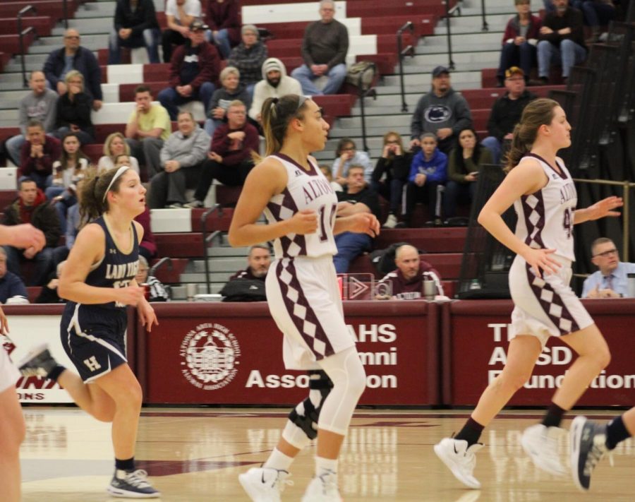Let’s go Lions! Seniors Olivia Hudson and Bridgid Fox run to grab the ball from an opponent during a home game. The game was held on Jan. 7 against Hollidaysburg. 