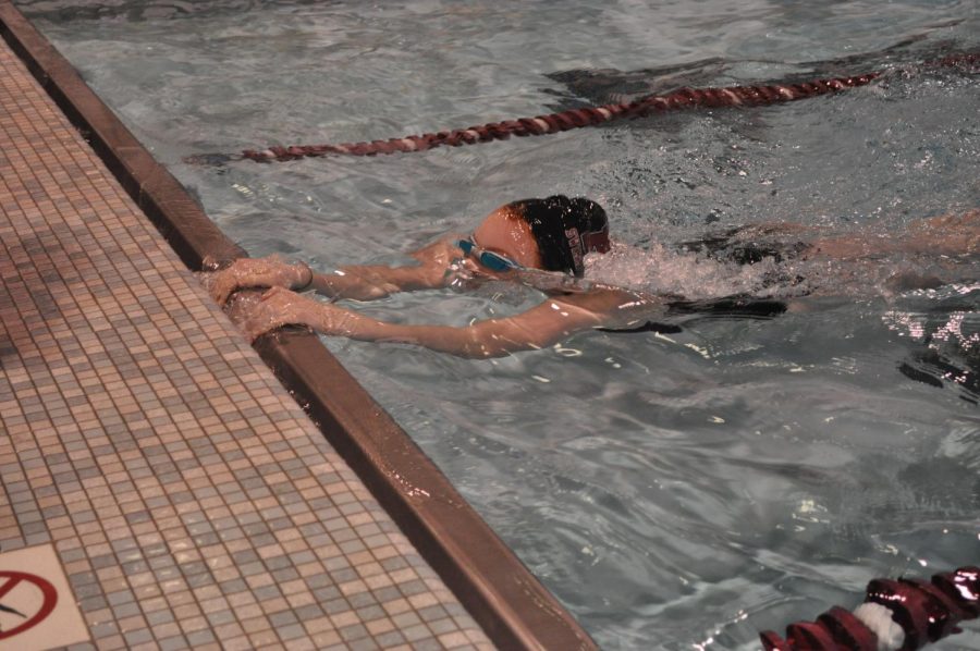 Sophomore Rylie Whitaker hits the wall during the Girls 100 Breaststroke.