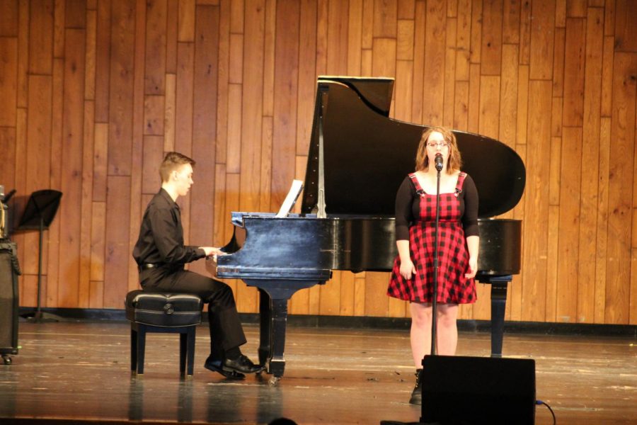 Senior Jake Kibler plays the piano as senior Emma Stewart sang 6/10.