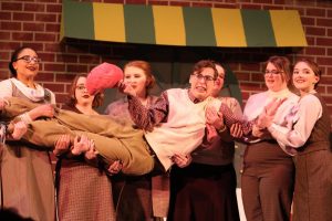 Mushnik and Son! Emily-Grace Garwood, Emma Stewart, Shelby Gallagher, Darrien Kerr, Madison Kuhns and Adrianna Huss hold Christian Howard during the song Ya Never Know. Garwood, Stewart, Gallagher, Kerr, Khuns, and Huss were part of the ensemble.
