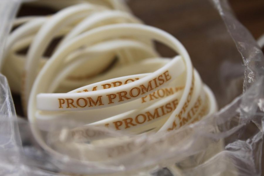 Bracelets are handed out to students who sign the prom promise 