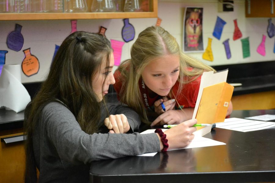 Look hard! Juniors Aaleah Neff and Sally Montgomery focus hard on a game in their seventh period forensic chemistry class. 
