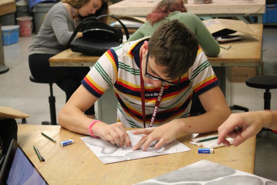 Sophomore Tanner Lechner blends his drawing to make it look seamless. In this art class, students also have to complete a weekly sketchbook drawing.