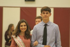 Senior Raquel Dunio and her escort, senior Wesley Young, represent chorus at the Homecoming assembly. At the assembly, candidates were introduced to the student body.  