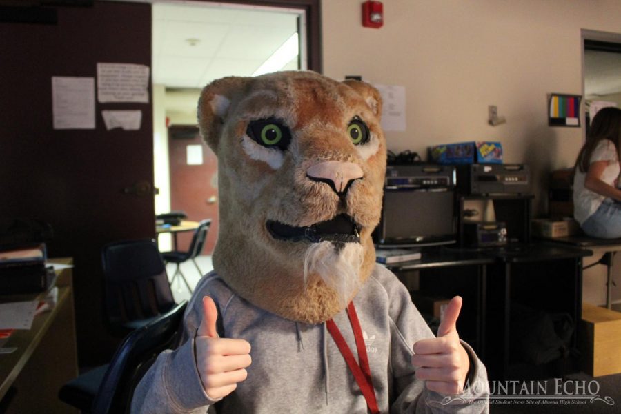 Sophomore Kayla Zeth puts on the Mountain Lion head for giggles during Broadcasting I. Zeth was waiting her turn to do the voice over for the MLTV. In Broadcasting I, students practice for each of the broadcasting positions.
