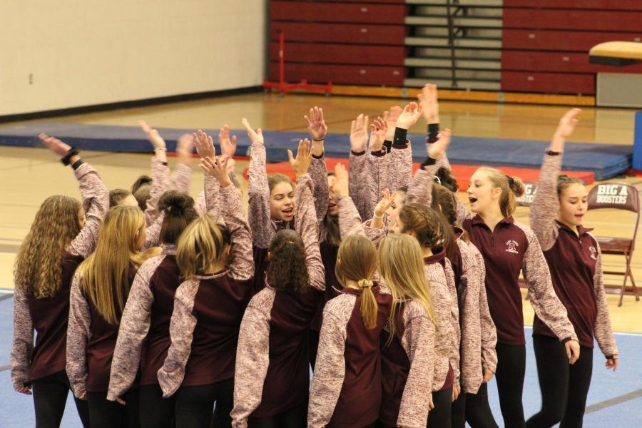 Go team! The team gets pumped up before they have to start competing. The team does this every meet. 