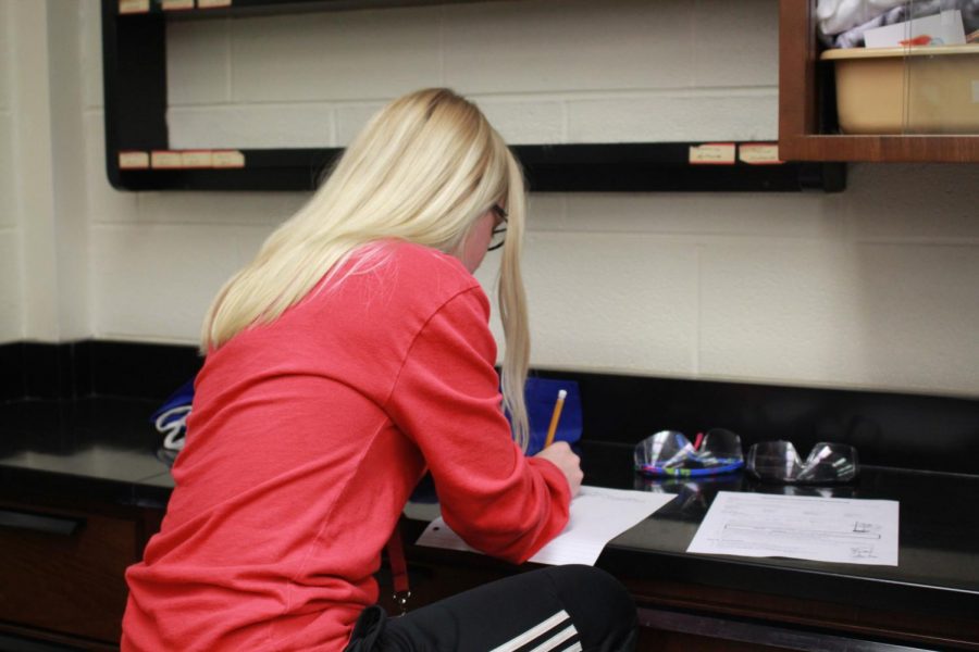 Sophomore Alanna Cunningham works on physics classwork days before the first marking period midterm. During the first midterm, students claimed to have plenty of time to study yet presently, students disagree with the midterm schedule. Many believe midterms should be held back or pushed further due to the eight-day holiday break.