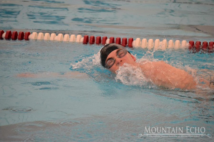 Senior Benjamin Neil takes a breath during the boys 400-yard relay. Neil also swam the boys 200-yard freestyle and 100-yard breaststroke. 
