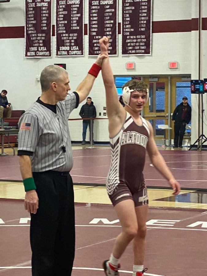 Standing tall. 
Junior Matthew Sarbo stands tall after winning at districts. He finally reached his goal of 100 wins.