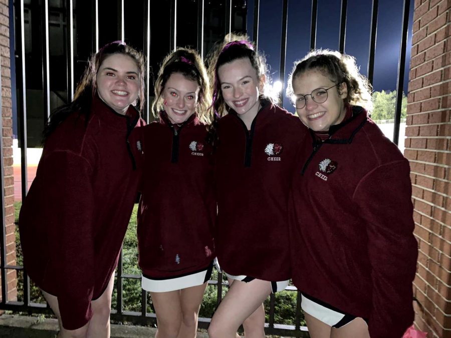 Yay! Adriana Kessler, Alyssa Kovach, Lizzy Frank and Paige Vallei pose for a picture after the Oct. 2 game. 