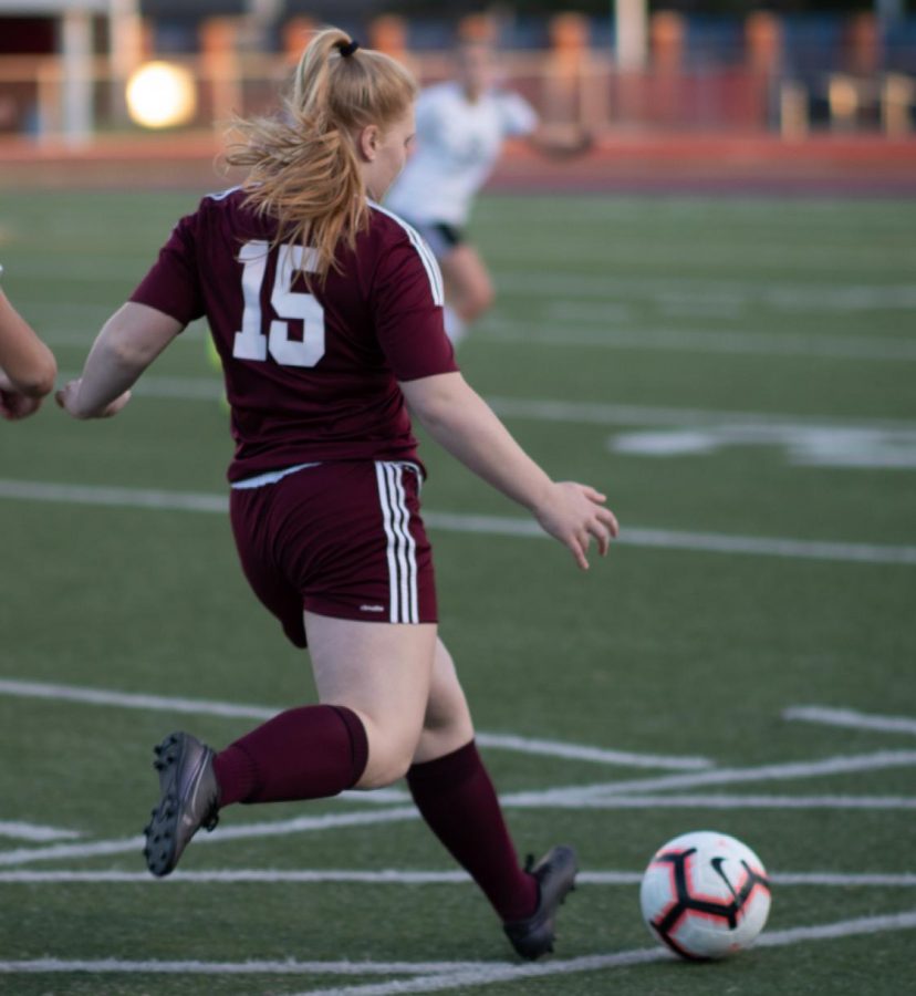 Shoot! Junior Becca Dull passes the ball to a teammate during the Oct. 2 game. The Mountain Lions competed against Dubois and won 4-0.