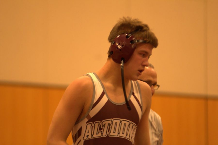 Whew! Sophomore Alexander Yost takes a breath during a 2019 wrestling match. The 2020 season has been postponed. 