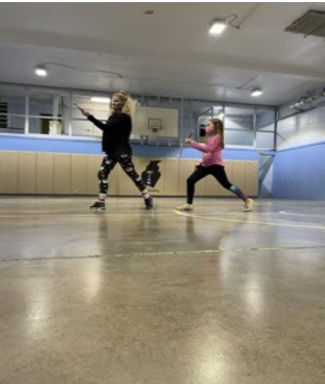 Twirler Arabella Wilt and Coach Renee Parowski lunge in preparation for the upcoming competition season. “I’m excited for competitions and I hope that I get the chance to do it with my friends,” Wilt said.