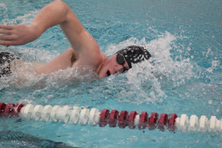 Senior Kyle Murray takes a breath while sprinting in the 100 yard freestyle. This is Murrays first year on the team. 