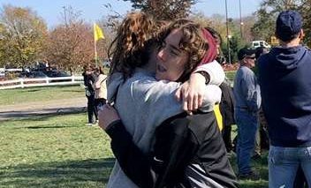 Hugging. 
Juniors Mackenzie and Aidan Kelley hug each other. They are twins and run cross country together.