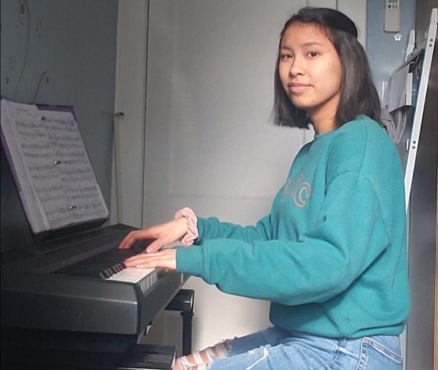 Practice practice practice! Sophomore Katie Hovan plays her piano at home. Many students, like Hovan, learned how to play an instrument both outside of school and in school.  
