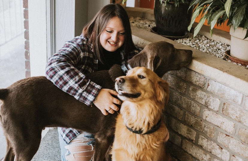 Say cheese! Ericka Selfridge hangs out with the pups while waiting to get her senior pictures taken. Selfridge got some of her pictures taken at a dog shelter. 