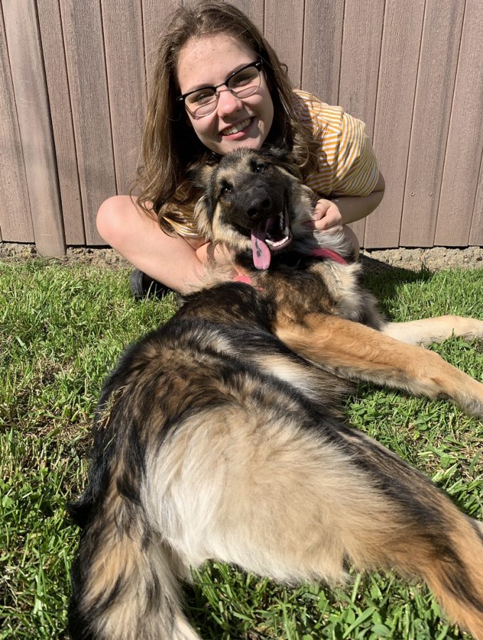 Senior Paige Vallei enjoys the nice day out with her dog!