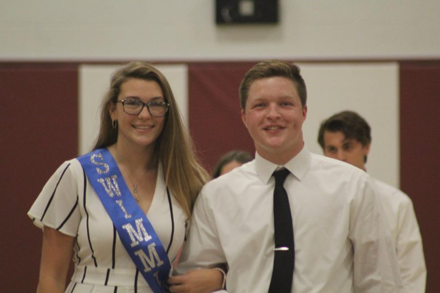 During last years Homecoming assembly the  representative of the swim team, Faith Milliron, and her escort, Rusty Focht, smile wide for the camera. This year, there will be no homecoming dance, but there will be a scavenger hunt and games night. 