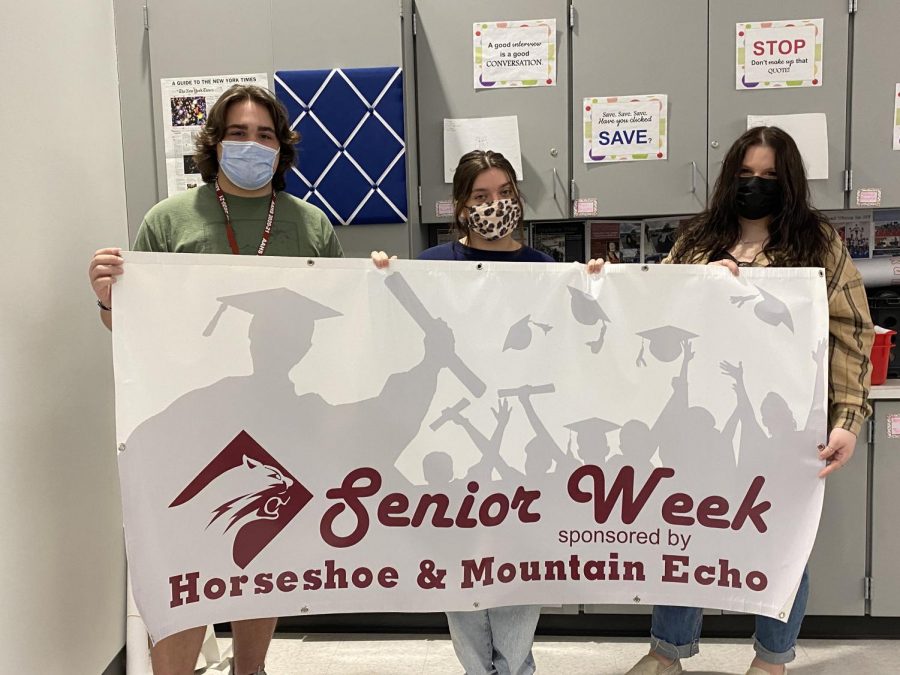 Say cheese! Seniors Ben Blackie, Sydney Wilfong and Jocelyn Fetter hold their senior week banner. The banner was donated by Image Signs and was designed by art teacher John King. 