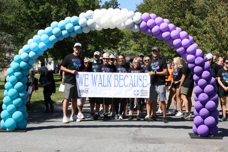 On your mark! Members of Gilligans Crew hold up the sign for the annual walk this year. The walk took place on Sept. 12.