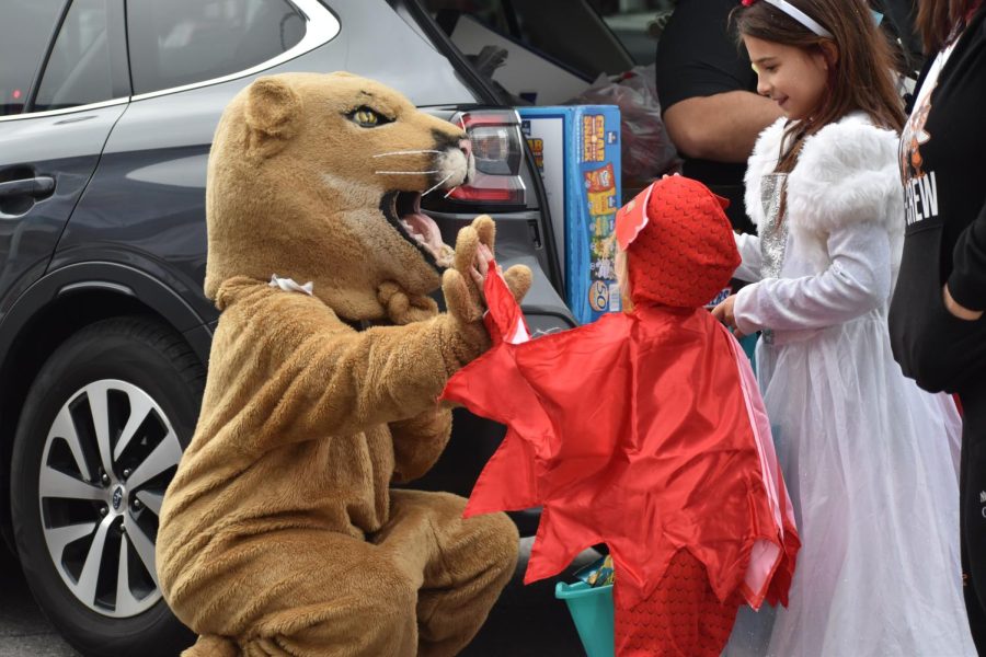 High Five! The mountain lion gives a high to a trunk or treater. The children and adults at trunk or treat had the opportunity to get a high five with the mountain lion. 