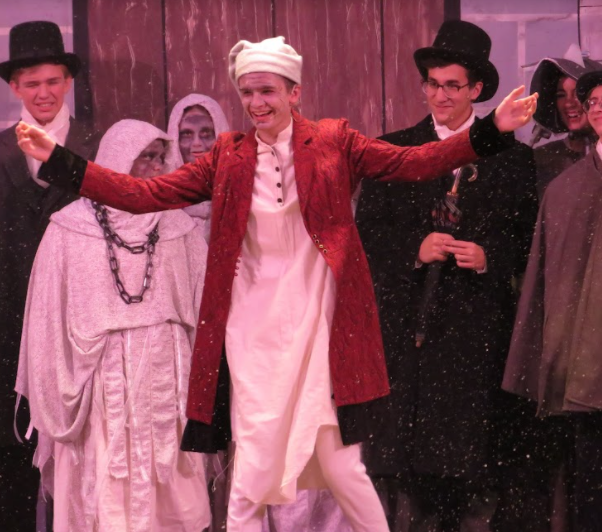 Merry Christmas Mr. Scrooge. Senior Luke Rokosky runs out from the wings as he receives a standing ovation from the crowd at the closing of the opening night. 