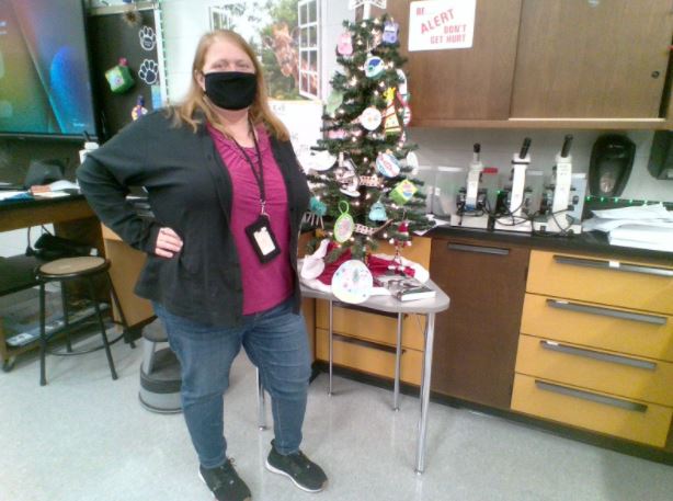 Science teacher Heather Partsch poses with the tree in her classroom.  Students will continue to add ornaments until the holiday break.