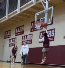 Freshman Mark Harrington watches Markell Herr make a lay up during practice at the junior high school.