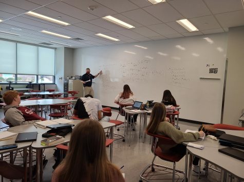 Explaining the problem. 
Math teacher Joseph Falger teaches Riemann Sums to his third period AP calculus class. Falger filled up the white board while solving one problem.