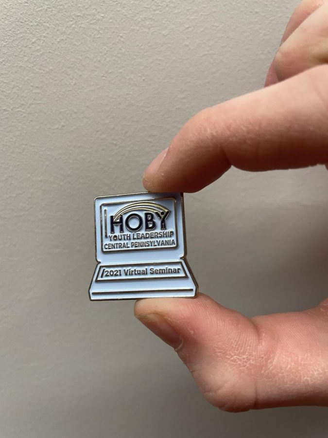 Junior Cassidy Klock shows off her HOBY pin; she received the pin last year during the virtual seminar.