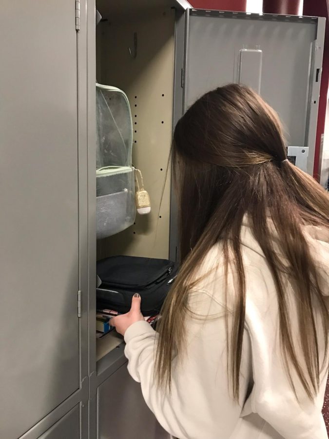 Open it up. Sophomore Leiya Resig opens her locker to get ready for the day. She opened her locker and grabbed her chrome book for first period.   