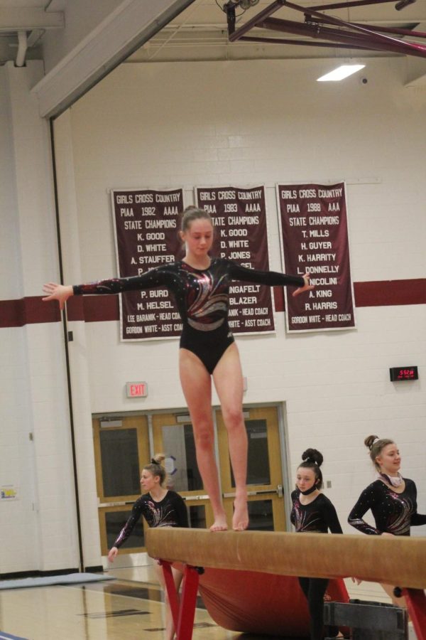 Balancing on the beam sophomore Sofia Fanelli carries out her routine on the beam. Im excited to see how the season will go since year and Im looking forward to making it to states, Fanelli said.