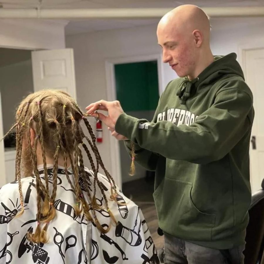 Donation time. 
Senior Aaron Chaplin cuts the hair off one of the participants at the fundraiser. Three people donated and Chaplin received monetary donations.