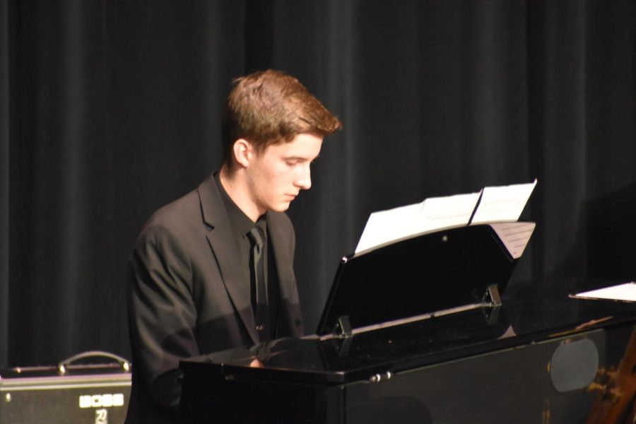 Hitting the keys. Junior Benjamin Wagner plays piano to Mr Blue Skies. Wagner performed with other students playing both wind and string instruments. 