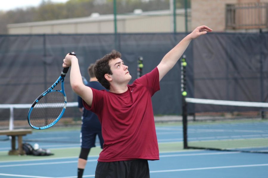 Serves up, Junior Mason Crownover serves his ball for the match. Crownover is also a member of the varsity team. 