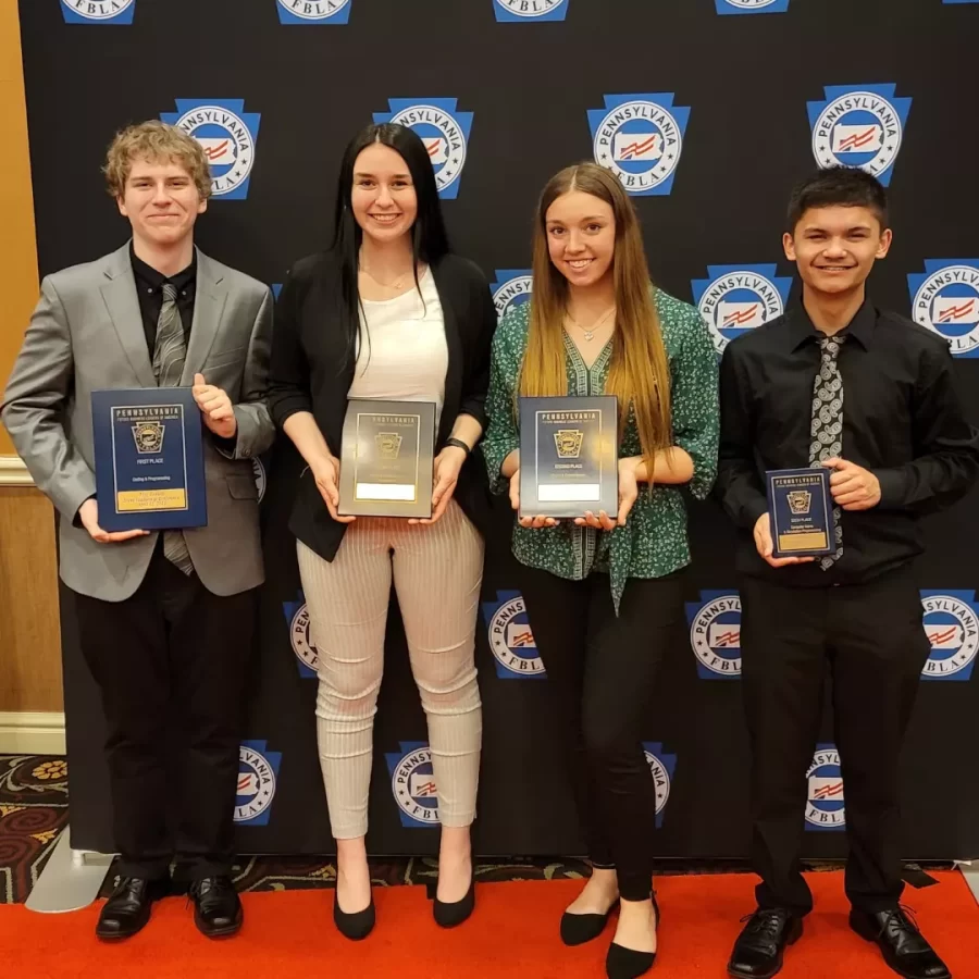 Qualified! Junior Tyler Houp, Sophmore Jake Yohn and Seniors Kaylee Smith and Emma Giles pose with their awards. They qualified for nationals which gives them the chance to compete in Chicago. 