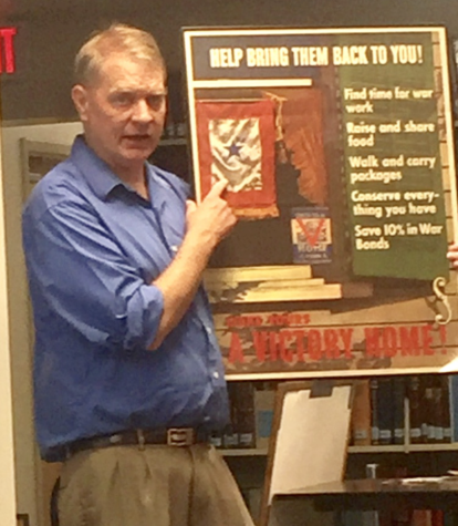 You be the historian. 
History teacher James Lowe shows his students a poster from World War II.  Lowe has many artifacts from this era. 