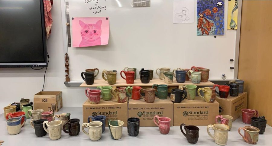 Cheers! Get any of these handcrafted mugs for $10. Go to B 229 to purchase one of these mugs. 