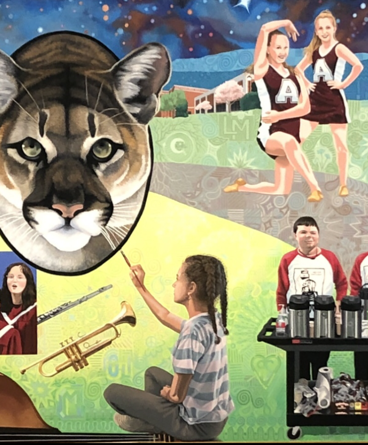 The+mountain+lion+in+the+front+hall+mural+looks+on+as+students+work.