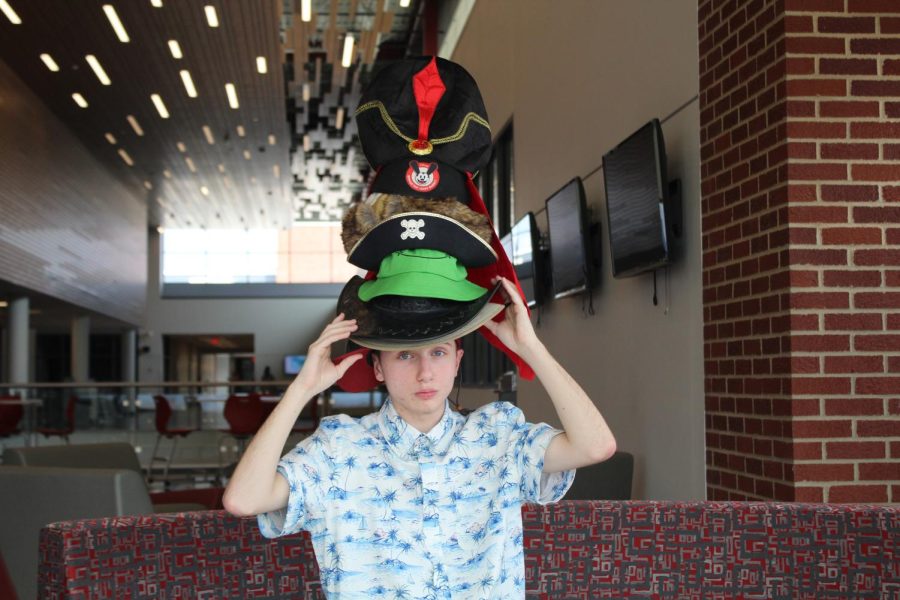 Senior Connor George poses with multiple hats. On Hats for Ukraine Day, George wore a different hat for each period of the day.
