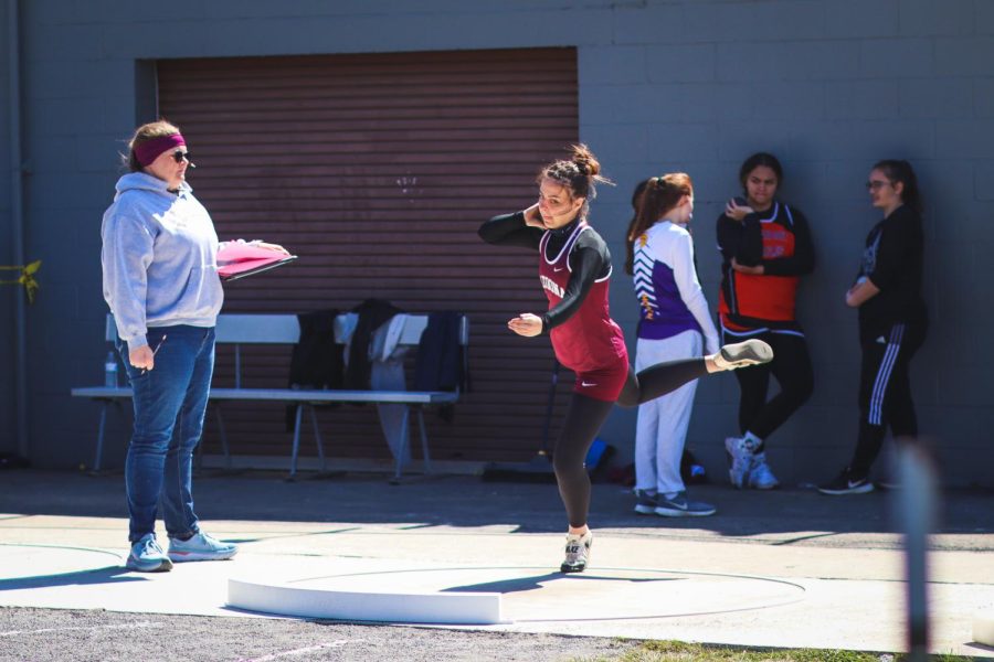 Twist and shout Senior Olivia Chille tests her strength in shot put. She threw the spherical weight while trying to get the perfect spin and balance. 