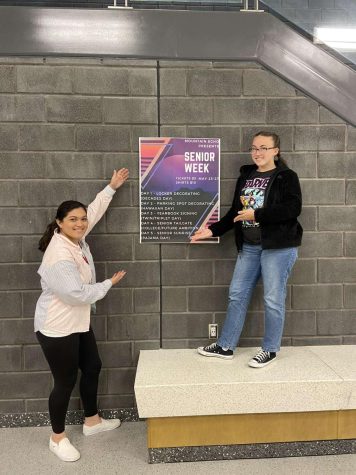Getting ready. 
Seniors Jayla Nartatez and Destiny Montgomery pose in front of a senior week poster. The senior week committee designed posters in order to prepare for ticket sales. 