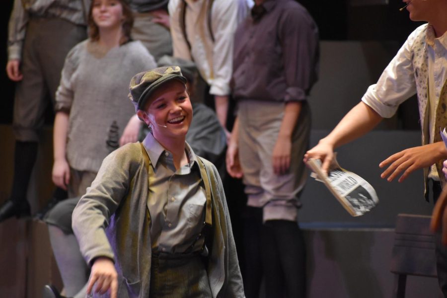 Eyes on the prize. Junior Keira Mayhue shows off her singing and acting skills as she celebrates the Newsies making the front cover. Mayhue played the role of Jojo.