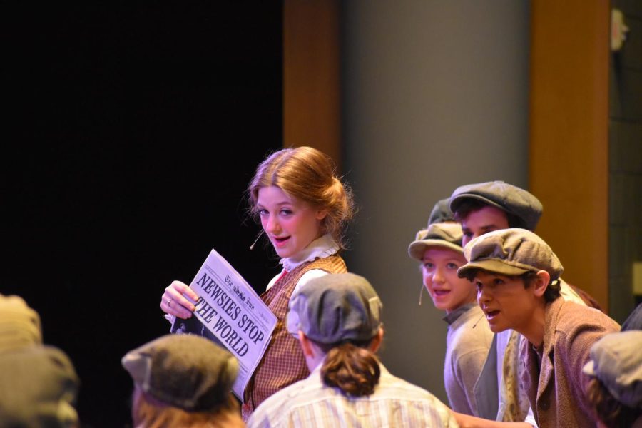 Take a look. Junior Gracie Crider shows off the front page of the newspaper. Her character published a story about the Newsies that made the front cover. 